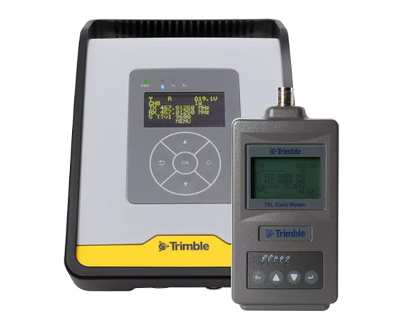 Two Trimble electronic devices on a white background