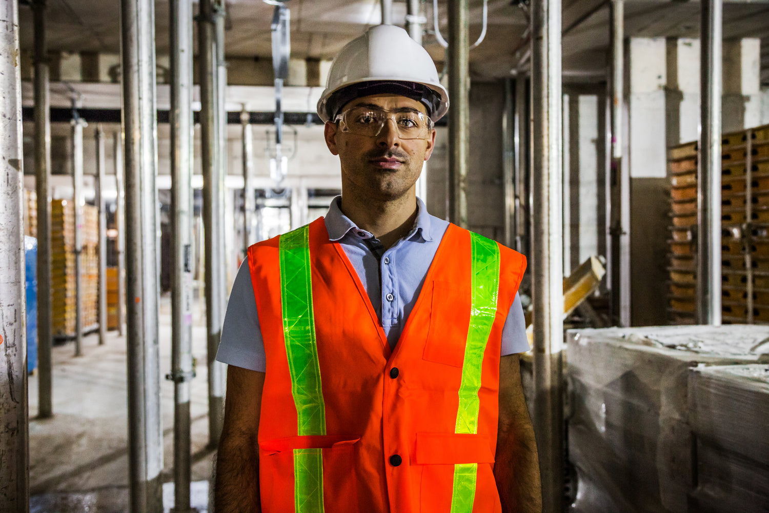 Construction Worker Wearing Orange Safety Gear on Jobsite